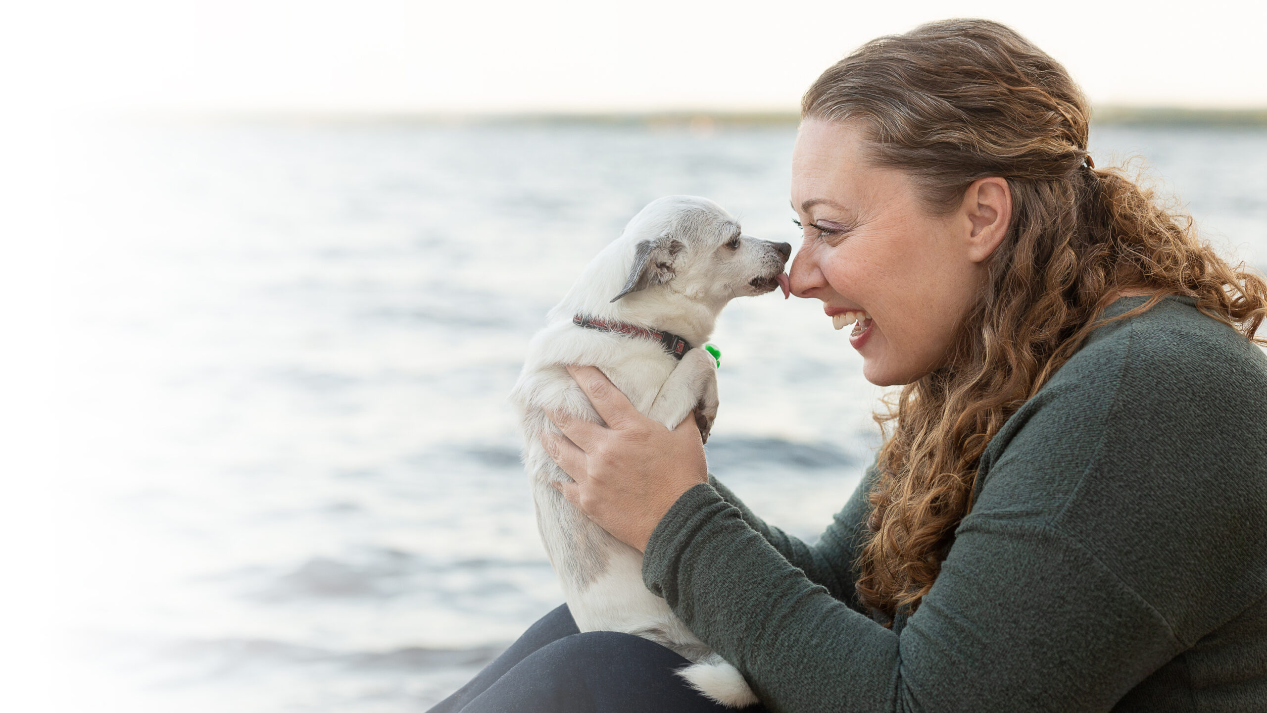 Stephanie Gibeault at a lake with a dog